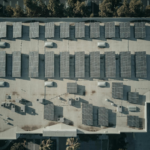 Discover the efficiency of solar energy with this aerial shot of solar panels on a rooftop.