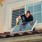 Solar technician installing a photovoltaic panel on a rooftop, promoting renewable energy.