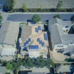 Aerial view of suburban houses equipped with solar panels for renewable energy.