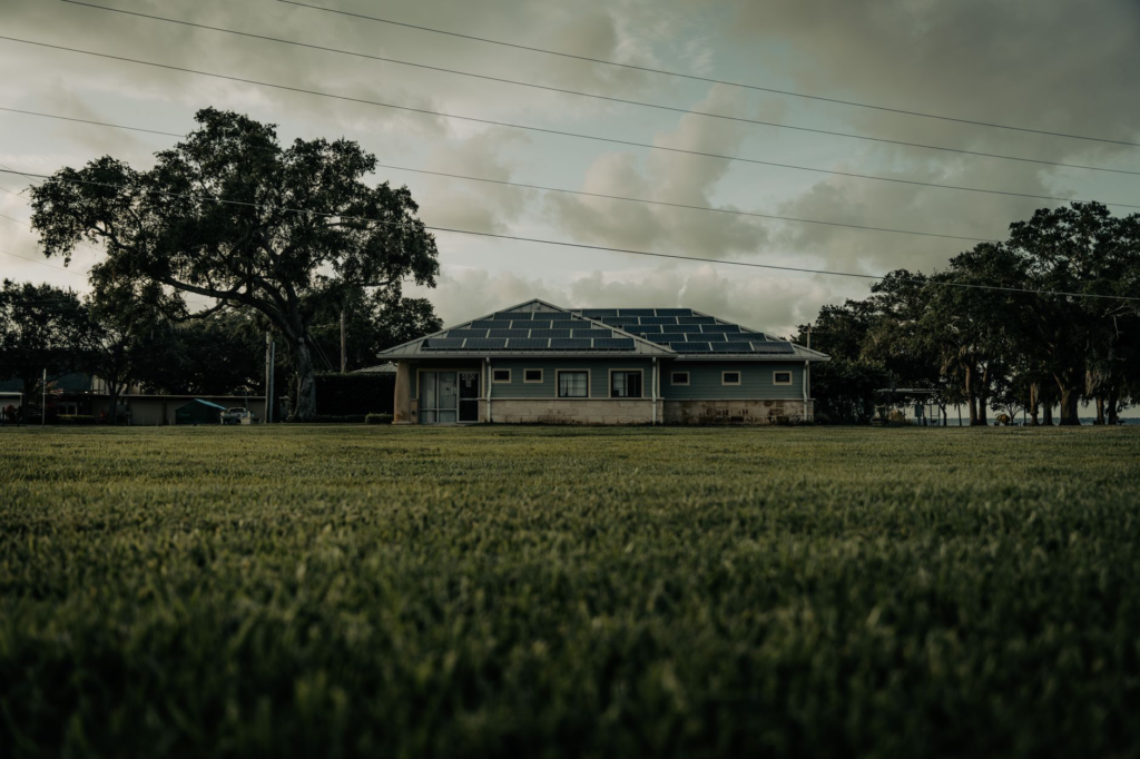 A sustainable home with solar panels in a lush Florida setting, showcasing green energy.