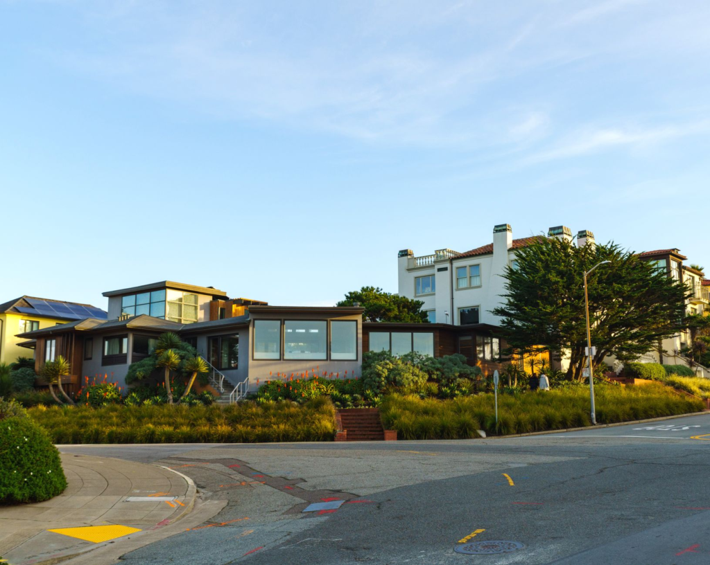A row of modern houses on a sunny corner showcasing contemporary architecture.