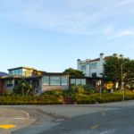 A row of modern houses on a sunny corner showcasing contemporary architecture.