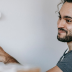 Happy man painting a wall at home, expressing joy and satisfaction.