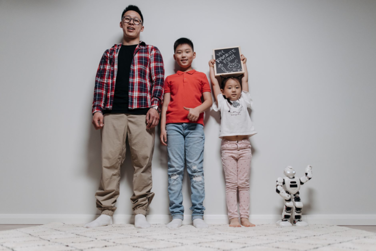 Indoor portrait of a happy family with two children and a robot, showcasing quality time together.