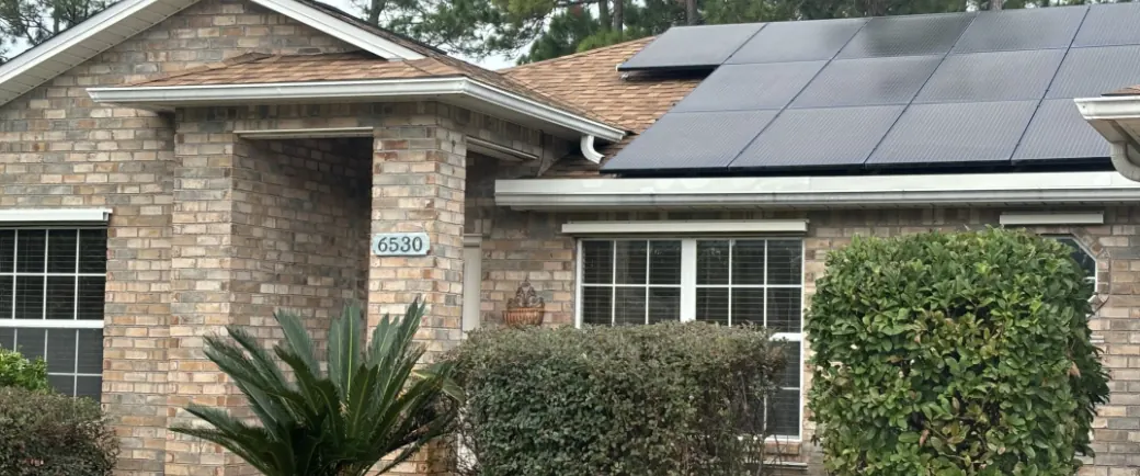 Black-on-black panel array on a brick home