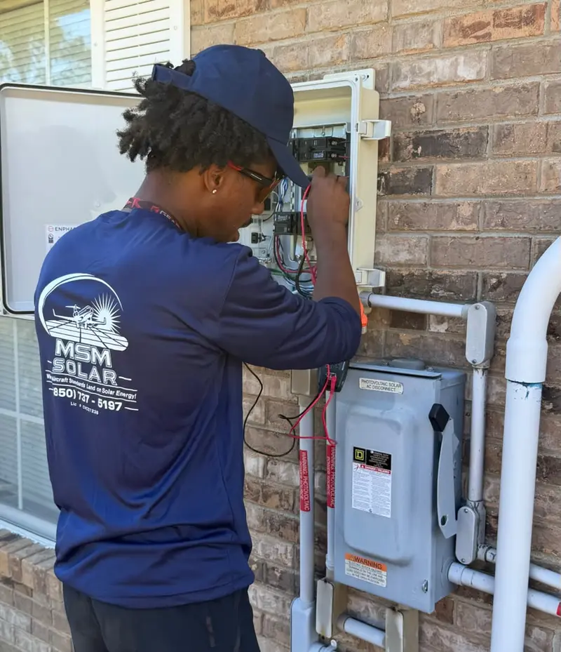 MSM Solar technician troubleshooting solar equipment on a service call