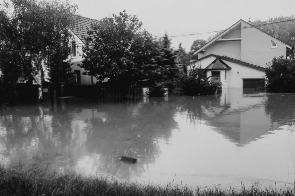 Suburban street with houses surrounded by floodwater